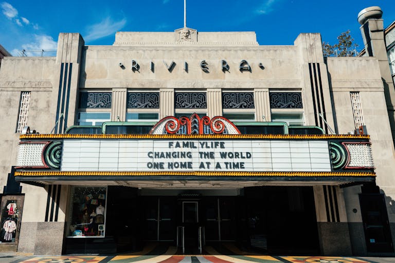 Historic Riviera Theater facade under a clear sky with vintage marquee sign.