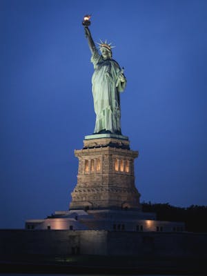 Stunning nighttime view of the Statue of Liberty on Liberty Island, New York City.