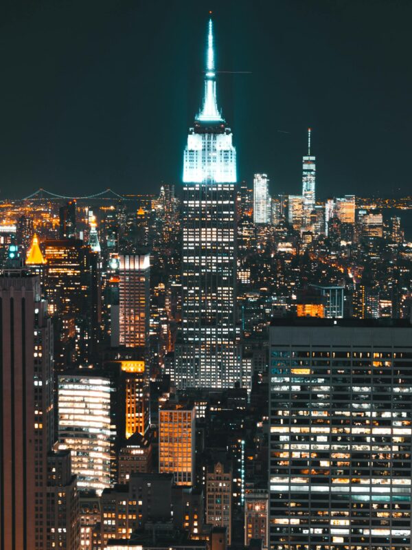 Stunning view of the Empire State Building illuminated amidst the New York City skyline at night.
