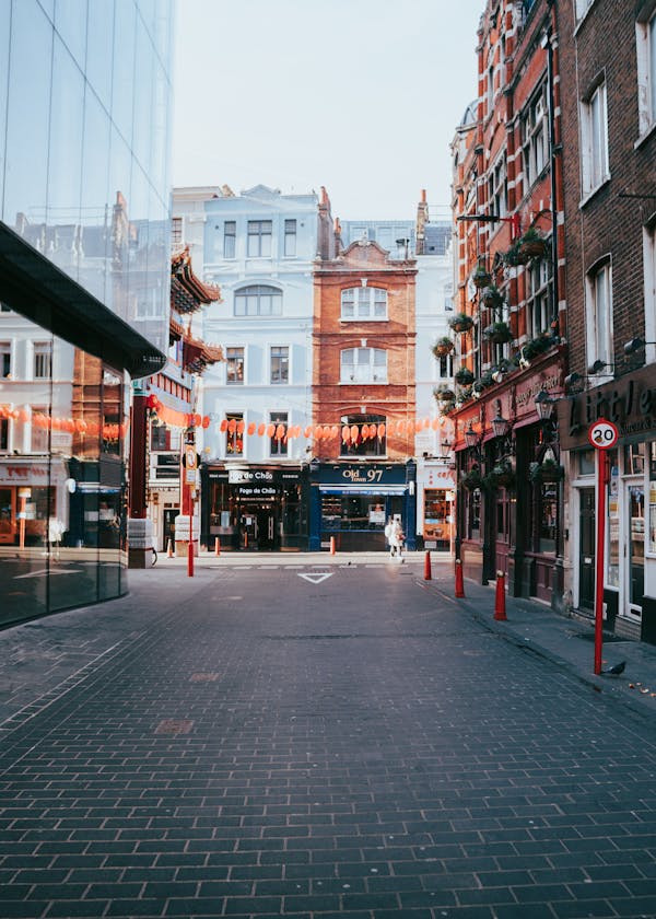 Vibrant urban street in Soho with architectural charm and decorations, perfect for cityscape enthusiasts.