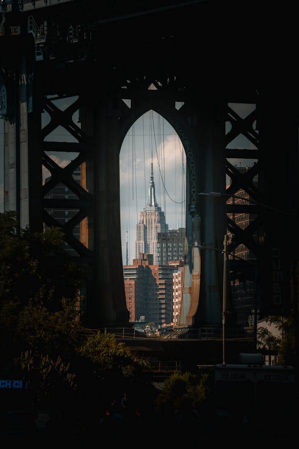 View of the Empire State Building through a bridge in New York City.